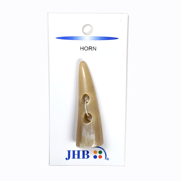 Pointed horn toggle button. Light tan in color. 2 inches