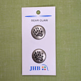 Silver metal button with bear paw imprinted; shank button; 3/4 inches